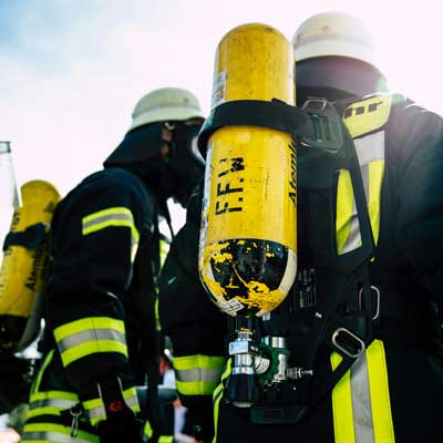 two firemen ready to go fight the fire